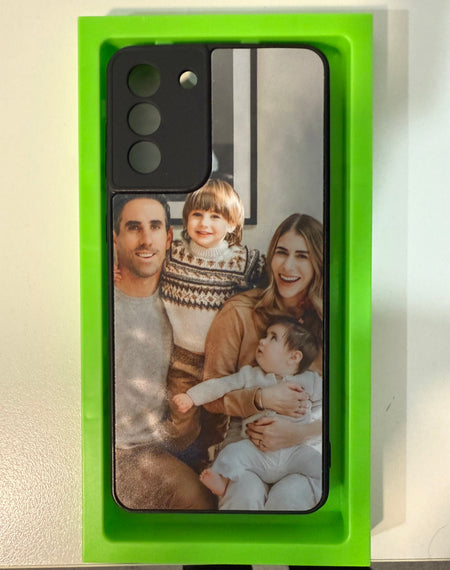 Custom phone case printed with a family portrait of parents and two young children in a green SnapShell tray